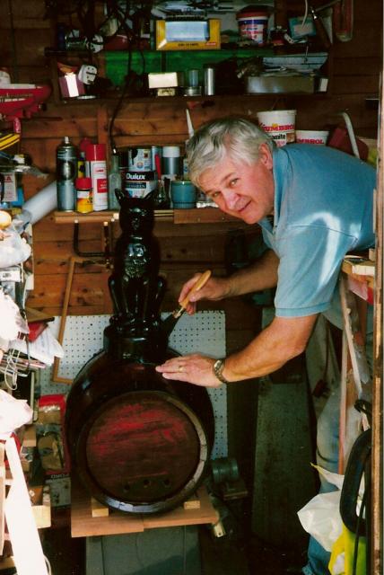 Melvyn Johnson repaints the cat and barrel in his workshhop